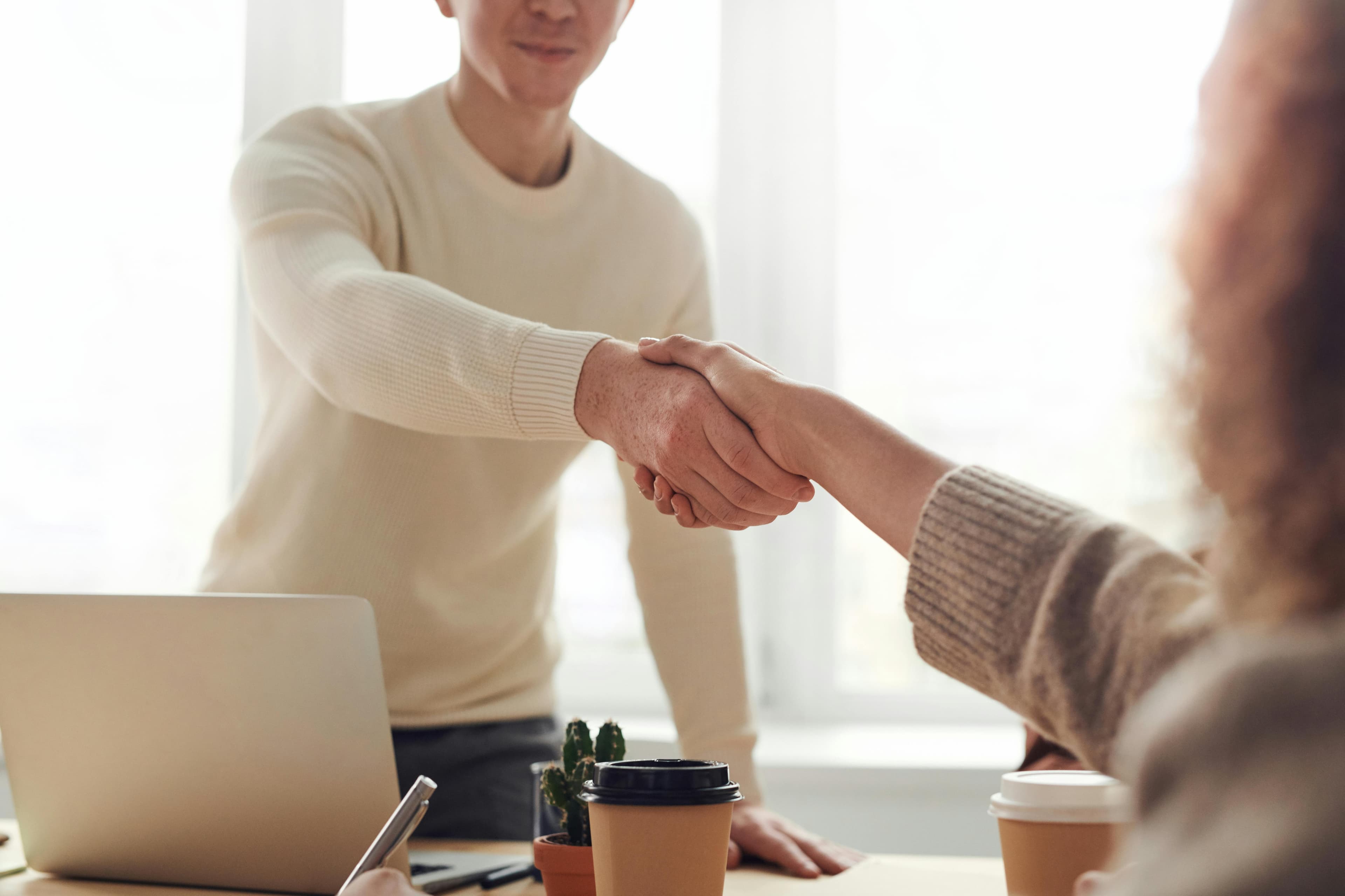 Business professionals shaking hands in a modern office